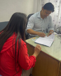 Dr. Rajan explaining advanced dermatology treatment options to patient during comprehensive consultation, showing before-and-after results